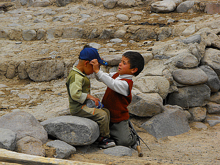 kids in the village (check out what the kid in brown sweater has as a toy...)